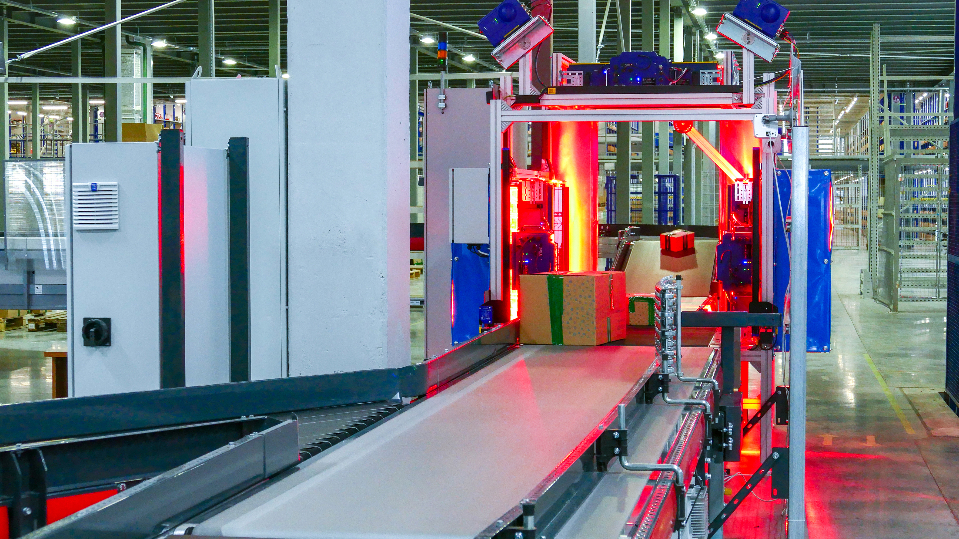 Parcels on a conveyor passing through an automated warehouse scanning station